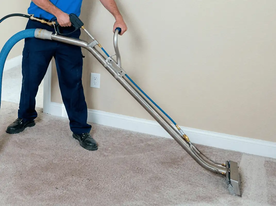 Professional operating a liquid removal machine on a carpeted floor in ,