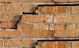 Brick wall with serious structural damage in ,